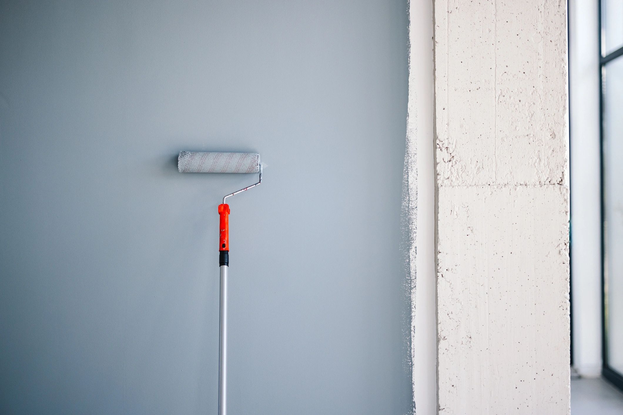 Painter applying a finish to an interior wall